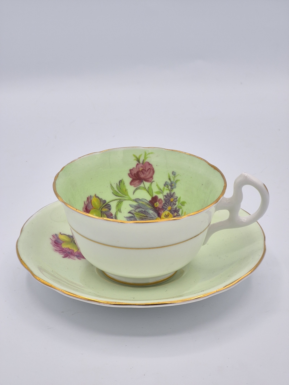 Hand-Painted Floral Porcelain Teacup and Saucer in Pale Green with Gold Trim